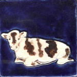 Cow resting cobalt, white and brown